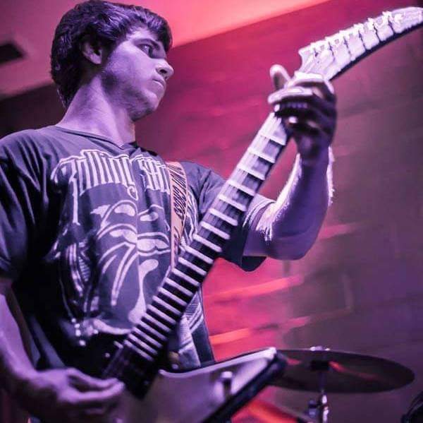 Coach Derek playing electric guitar