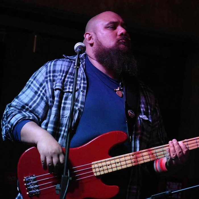 Coach Logan playing bass on stage